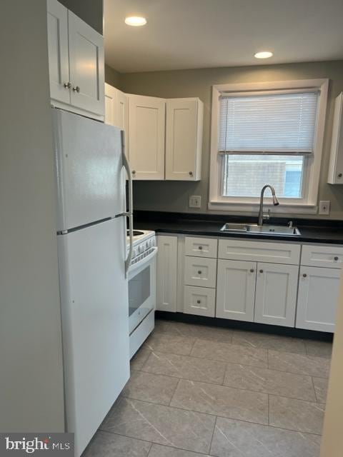 8 Florence Tollgate Pl, Florence, NJ 08518 - kitchen with white appliances, a sink, dark countertops, white cabinetry, and recessed lighting