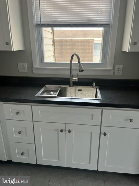 8 Florence Tollgate Pl, Florence, NJ 08518 - kitchen with dark countertops, a sink, white cabinets, and tile patterned flooring