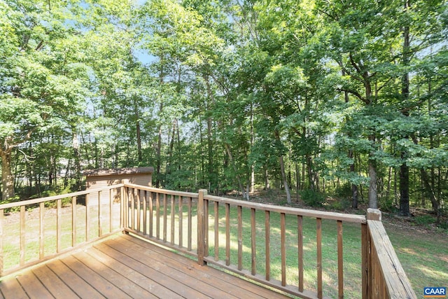 406 Green Meadow Ln, Scottsville, VA 24590 - wooden deck featuring an outdoor structure, a yard, and view of wooded area