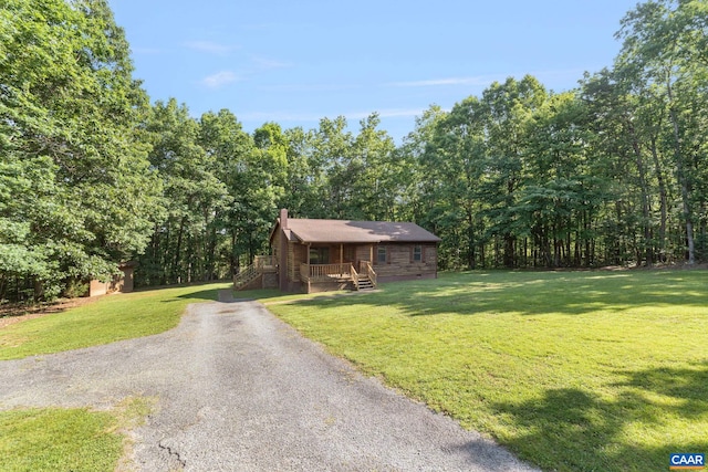 406 Green Meadow Ln, Scottsville, VA 24590 - view of front facade featuring a front lawn, a chimney, driveway, and a forest view