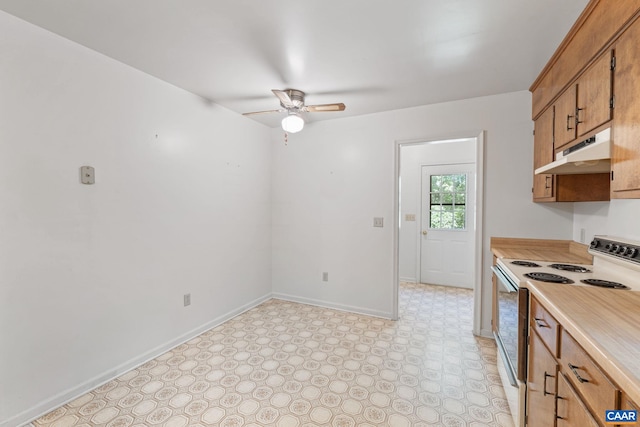 406 Green Meadow Ln, Scottsville, VA 24590 - kitchen with white range with electric stovetop, under cabinet range hood, ceiling fan, light countertops, and brown cabinetry