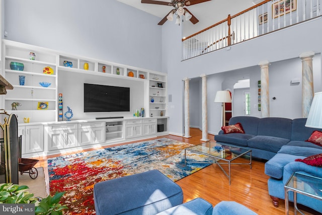 505 Sherwood Mills Ct, Sandy Spring, MD 20860 - living room featuring ceiling fan, light wood-style floors, a high ceiling, and decorative columns