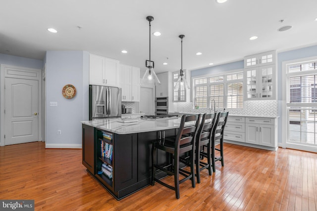 505 Sherwood Mills Ct, Sandy Spring, MD 20860 - kitchen with stainless steel appliances, white cabinetry, light wood-style flooring, and recessed lighting