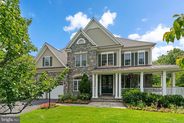 505 Sherwood Mills Ct, Sandy Spring, MD 20860 - view of front facade featuring a standing seam roof, stone siding, covered porch, and a front lawn