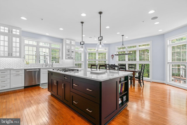 505 Sherwood Mills Ct, Sandy Spring, MD 20860 - kitchen featuring appliances with stainless steel finishes, light wood-style floors, open shelves, white cabinets, and decorative backsplash