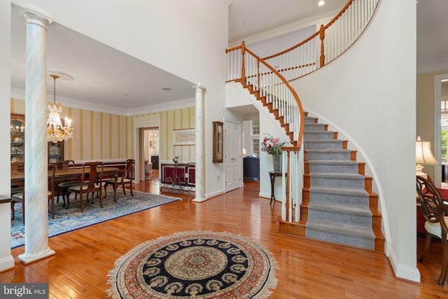 505 Sherwood Mills Ct, Sandy Spring, MD 20860 - foyer entrance with wood-type flooring, stairway, ornamental molding, decorative columns, and wallpapered walls