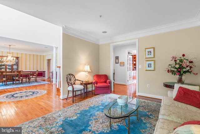 505 Sherwood Mills Ct, Sandy Spring, MD 20860 - living area featuring wood finished floors, crown molding, a chandelier, baseboards, and ornate columns