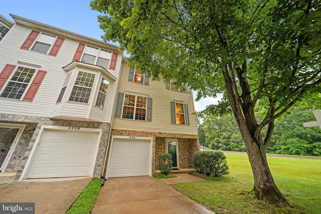 5341 Yellow Turtle Pl, Woodbridge, VA 22193 - multi unit property featuring concrete driveway, a front lawn, an attached garage, and stone siding