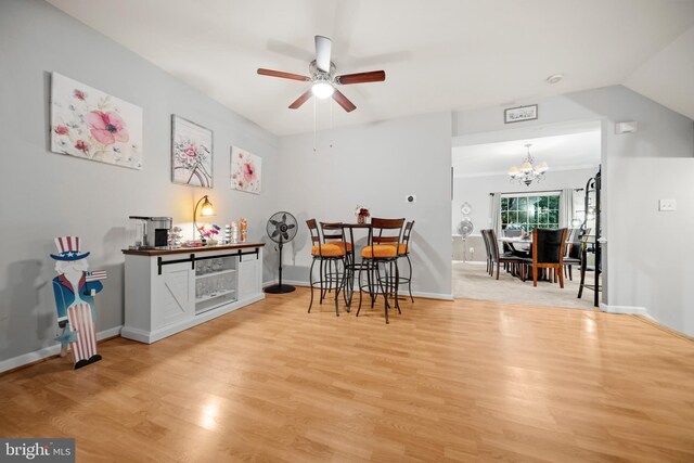 5341 Yellow Turtle Pl, Woodbridge, VA 22193 - dining space featuring ceiling fan, a chandelier, wood finished floors, and vaulted ceiling