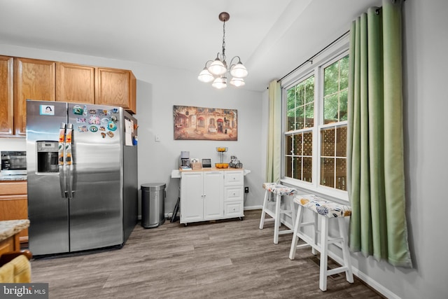 5341 Yellow Turtle Pl, Woodbridge, VA 22193 - kitchen featuring stainless steel fridge with ice dispenser, a chandelier, wood finished floors, light countertops, and hanging light fixtures