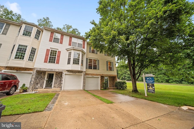 5341 Yellow Turtle Pl, Woodbridge, VA 22193 - view of property with concrete driveway, an attached garage, and a front yard