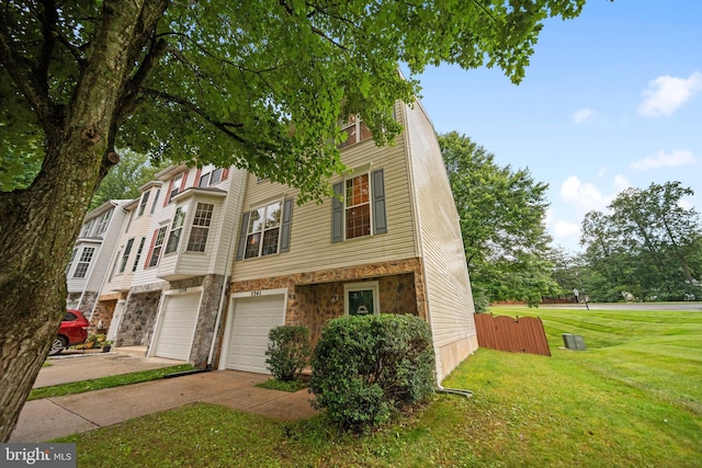 5341 Yellow Turtle Pl, Woodbridge, VA 22193 - townhome / multi-family property featuring driveway, stone siding, a front lawn, and a garage