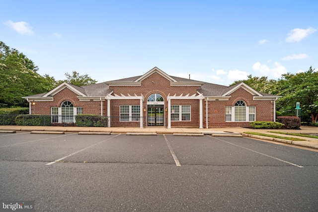 5341 Yellow Turtle Pl, Woodbridge, VA 22193 - view of front facade featuring uncovered parking, brick siding, and roof with shingles