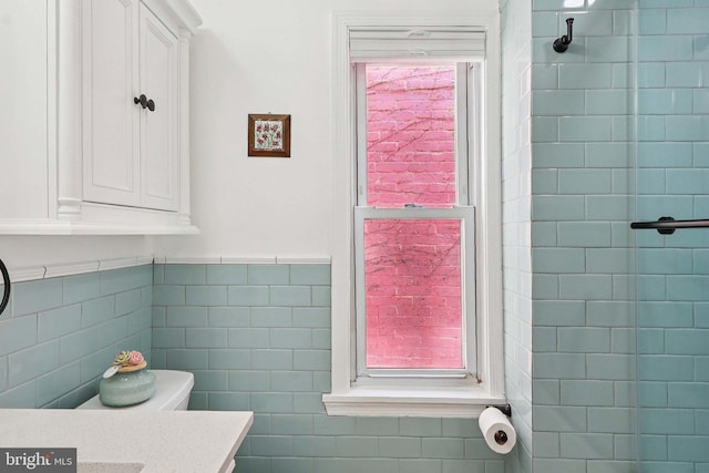 2254 12th St NW, Washington, DC 20009 - bathroom with vanity, a wainscoted wall, toilet, and tile walls
