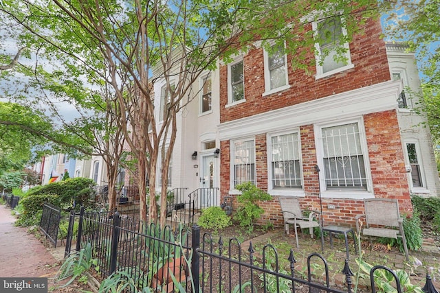 2254 12th St NW, Washington, DC 20009 - townhome / multi-family property featuring a fenced front yard and brick siding