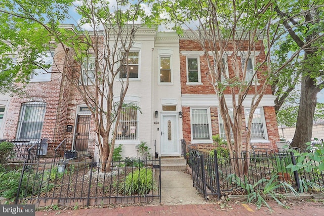 2254 12th St NW, Washington, DC 20009 - townhome / multi-family property with brick siding and a fenced front yard