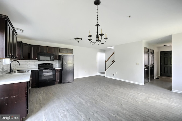 555 Kentwell Dr, York, PA 17406 - kitchen featuring black appliances, light countertops, a chandelier, backsplash, and light wood-type flooring