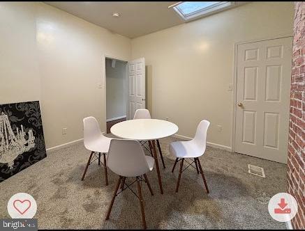 321 Elm St NW, Washington, DC 20001 - carpeted dining room with a skylight and baseboards