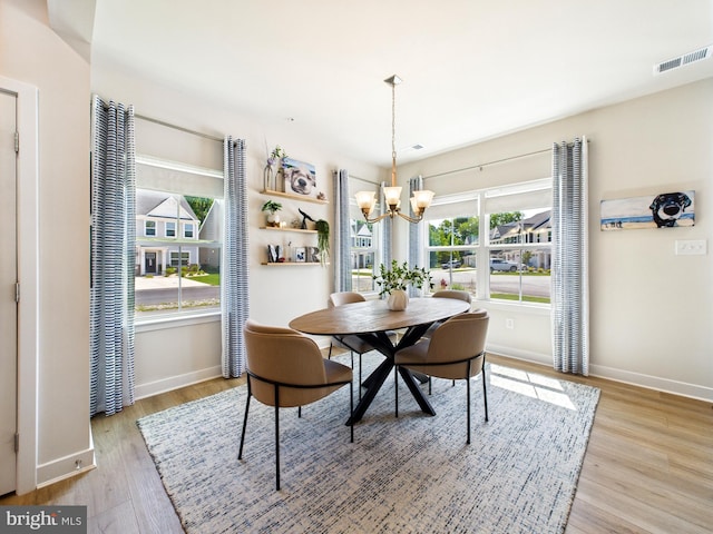 11020 Augusta Ln Unit 3, Berlin, MD 21811 - dining space featuring a chandelier, baseboards, wood finished floors, and plenty of natural light