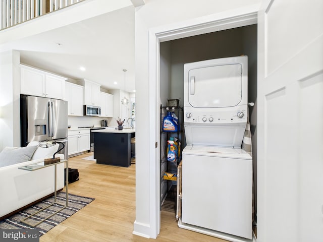 11020 Augusta Ln Unit 3, Berlin, MD 21811 - laundry area with stacked washer / drying machine, light wood-style flooring, and recessed lighting