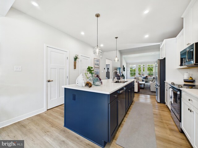 11020 Augusta Ln Unit 3, Berlin, MD 21811 - kitchen featuring appliances with stainless steel finishes, light wood-style floors, a center island with sink, white cabinetry, and recessed lighting