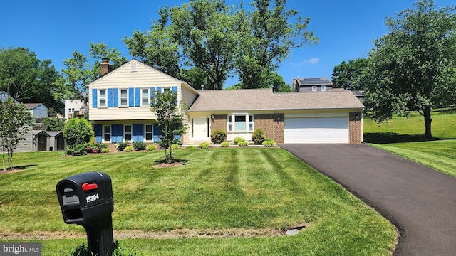 15204 Watergate Rd, Silver Spring, MD 20905 - tri-level home featuring a garage, a chimney, driveway, brick siding, and a front lawn