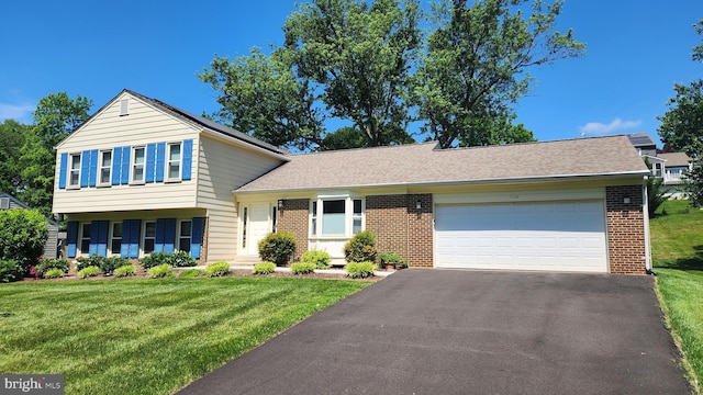 15204 Watergate Rd, Silver Spring, MD 20905 - split level home featuring brick siding, asphalt driveway, an attached garage, and a front lawn