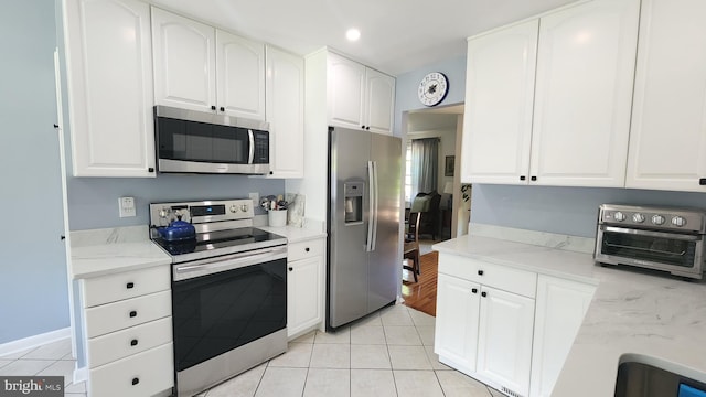15204 Watergate Rd, Silver Spring, MD 20905 - kitchen with stainless steel appliances, light tile patterned flooring, white cabinetry, and recessed lighting