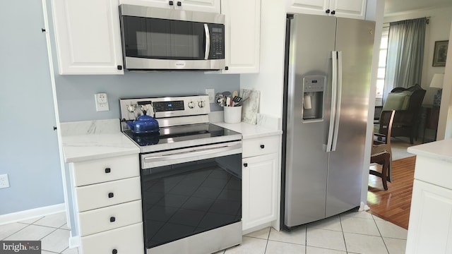 15204 Watergate Rd, Silver Spring, MD 20905 - kitchen featuring stainless steel appliances, light tile patterned floors, white cabinets, and light countertops