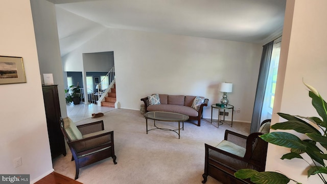 15204 Watergate Rd, Silver Spring, MD 20905 - living room featuring healthy amount of natural light, stairs, vaulted ceiling, light carpet, and baseboards