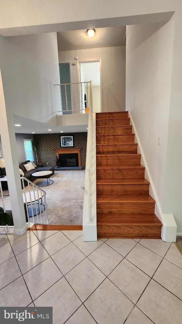 15204 Watergate Rd, Silver Spring, MD 20905 - staircase with tile patterned flooring, a fireplace, and baseboards