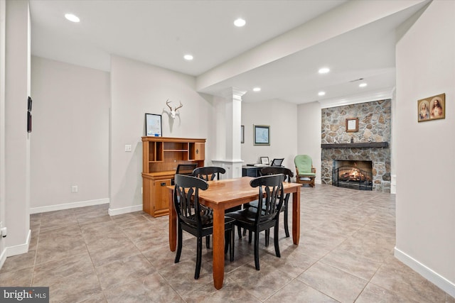 8112 Vista Point Ln, Fairfax Station, VA 22039 - dining space featuring ornate columns, recessed lighting, a stone fireplace, baseboards, and light tile patterned floors