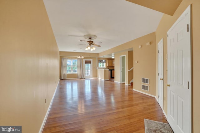 2325 Slater Hill Ln E Unit 39, York, PA 17406 - unfurnished living room with light wood-style floors, baseboards, a ceiling fan, stairs, and a chandelier