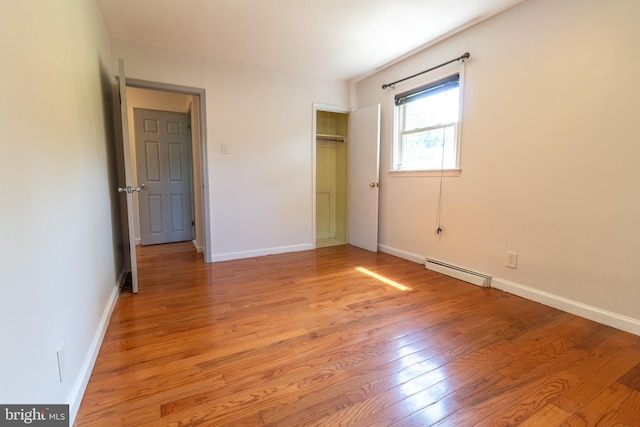 1545 Shoemaker Rd, Abington, PA 19001 - unfurnished bedroom with a baseboard heating unit, light wood-style floors, and a closet