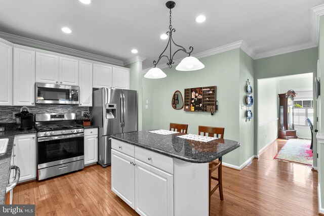 1412 Eagle Ridge Run, Bel Air, MD 21014 - kitchen with appliances with stainless steel finishes, a breakfast bar, crown molding, white cabinets, and a kitchen island