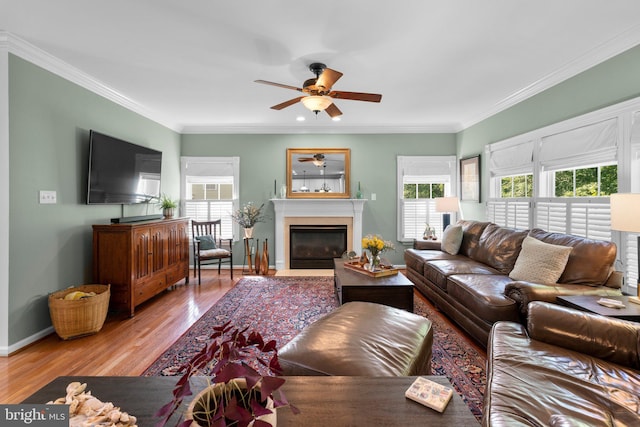 1412 Eagle Ridge Run, Bel Air, MD 21014 - living room featuring ceiling fan, wood finished floors, crown molding, a glass covered fireplace, and baseboards