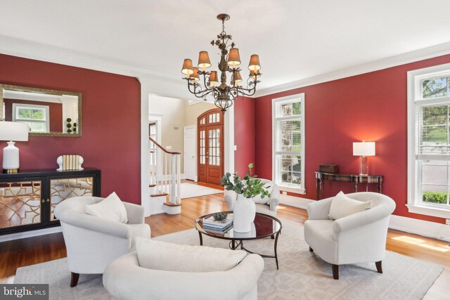 2 Autumn Meadow Ln, Malvern, PA 19355 - living area featuring wood finished floors, a chandelier, ornamental molding, stairs, and baseboards