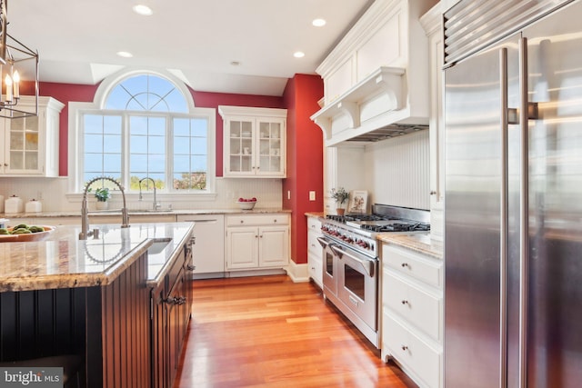 2 Autumn Meadow Ln, Malvern, PA 19355 - kitchen featuring premium appliances, light wood-style floors, white cabinets, recessed lighting, and light stone countertops