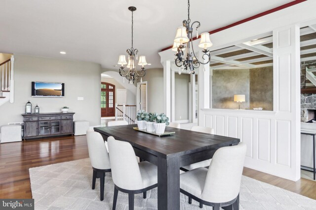 2 Autumn Meadow Ln, Malvern, PA 19355 - dining space featuring a chandelier, stairs, arched walkways, wood finished floors, and recessed lighting