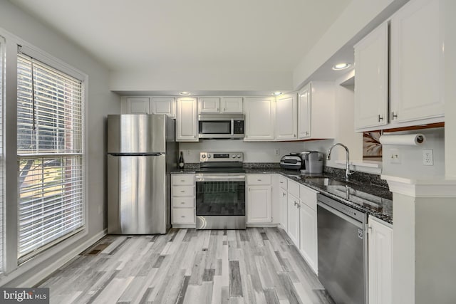 608 Budleigh Cir, Lutherville Timonium, MD 21093 - kitchen featuring stainless steel appliances, white cabinets, dark stone counters, light wood finished floors, and recessed lighting