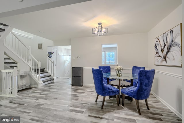 608 Budleigh Cir, Lutherville Timonium, MD 21093 - dining space featuring stairs, wood finished floors, and a chandelier