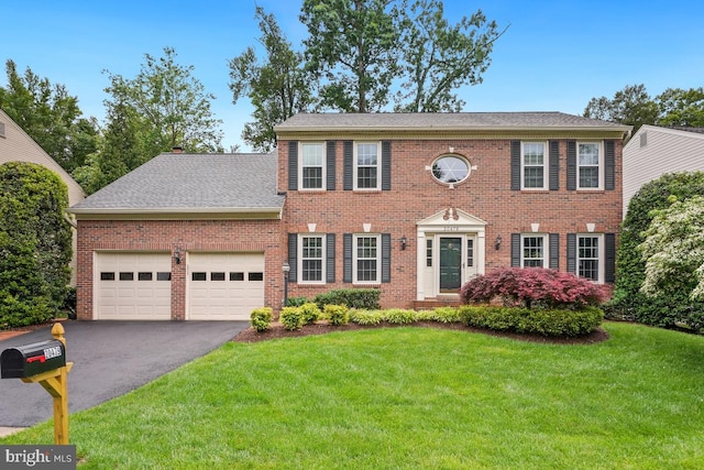 20479 Quarterpath Trace Cir, Sterling, VA 20165 - colonial inspired home featuring asphalt driveway, a garage, a front yard, brick siding, and roof with shingles