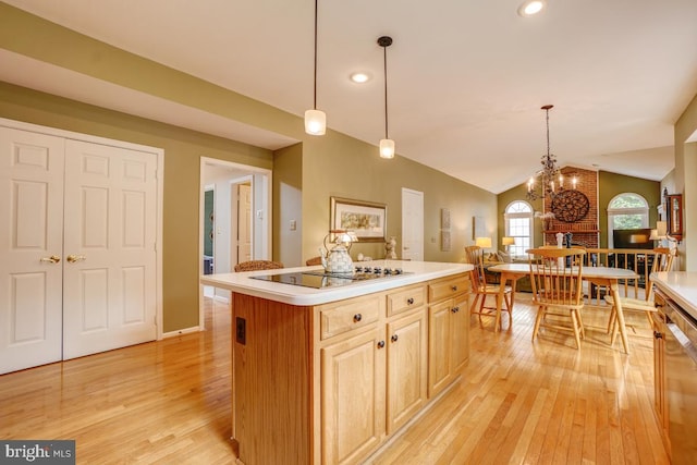 20479 Quarterpath Trace Cir, Sterling, VA 20165 - kitchen featuring light wood-type flooring, vaulted ceiling, a kitchen island, light countertops, and a chandelier