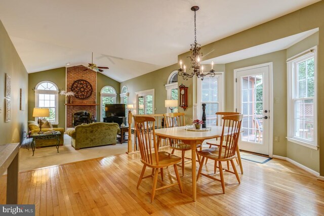20479 Quarterpath Trace Cir, Sterling, VA 20165 - dining room with light wood-style flooring, a fireplace, plenty of natural light, ceiling fan, and vaulted ceiling