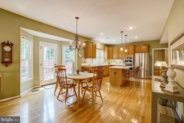 20479 Quarterpath Trace Cir, Sterling, VA 20165 - dining room featuring light wood finished floors, baseboards, a chandelier, and recessed lighting