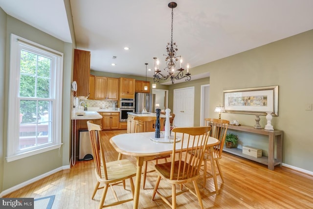 20479 Quarterpath Trace Cir, Sterling, VA 20165 - dining area with baseboards, light wood-style floors, a chandelier, and recessed lighting