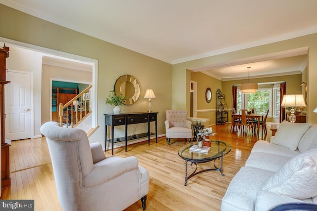20479 Quarterpath Trace Cir, Sterling, VA 20165 - living area featuring crown molding, light wood-type flooring, stairway, and baseboards