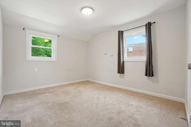 2816 Denley Pl, Silver Spring, MD 20906 - carpeted empty room featuring vaulted ceiling and plenty of natural light