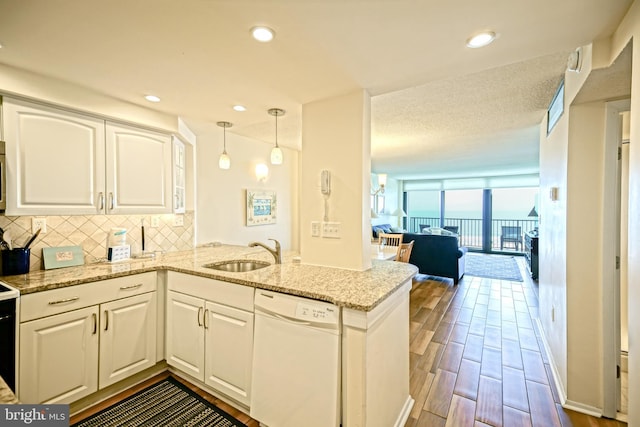 604 Dover House Rd Unit 604S, Bethany Beach, DE 19930 - kitchen with dishwasher, a sink, backsplash, white cabinets, and light stone counters