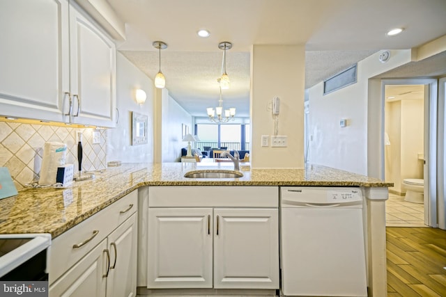 604 Dover House Rd Unit 604S, Bethany Beach, DE 19930 - kitchen featuring white dishwasher, a sink, white cabinetry, and backsplash